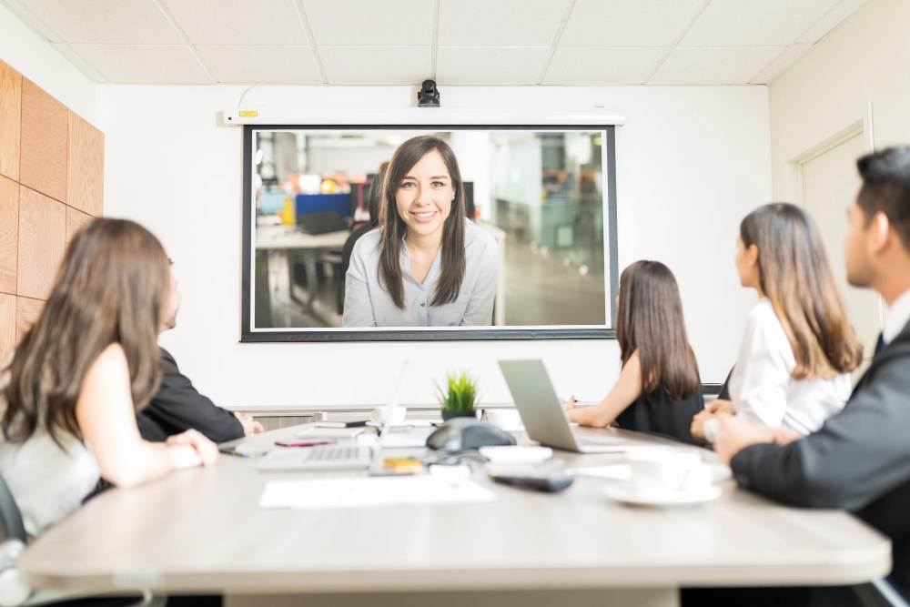 A conference room with large screen video chatting